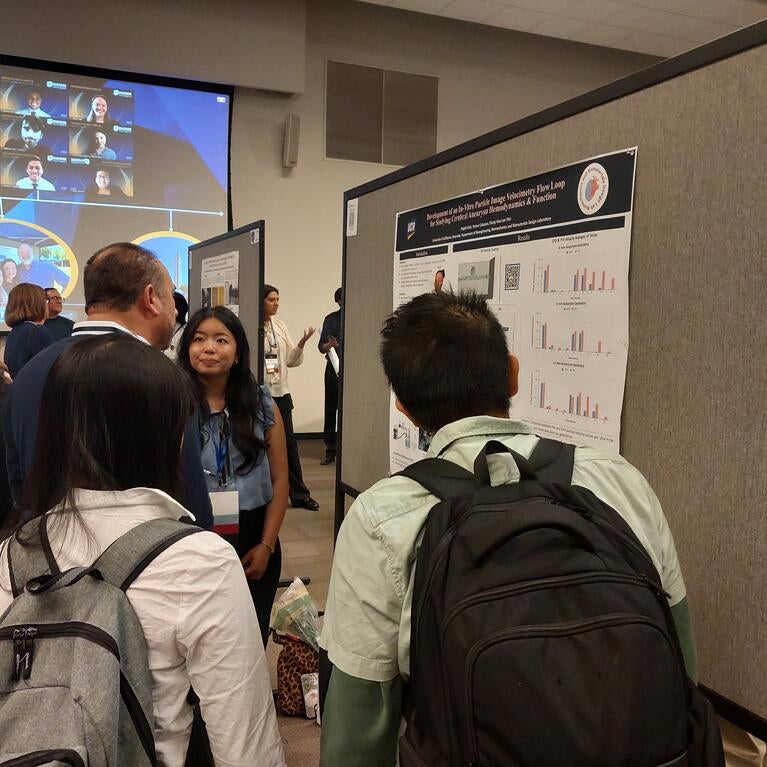 Phiphi discussing poster undergrad symposium 2026
