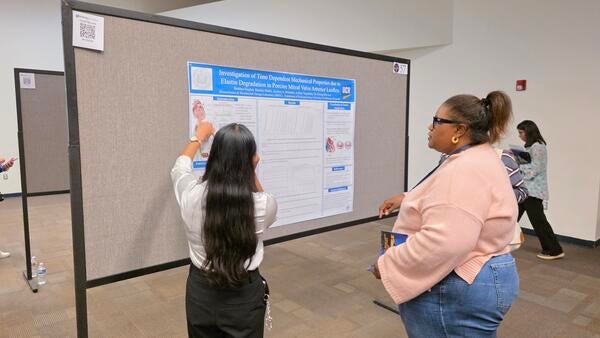 Shubi discussing research 2 undergrad symposium 2026